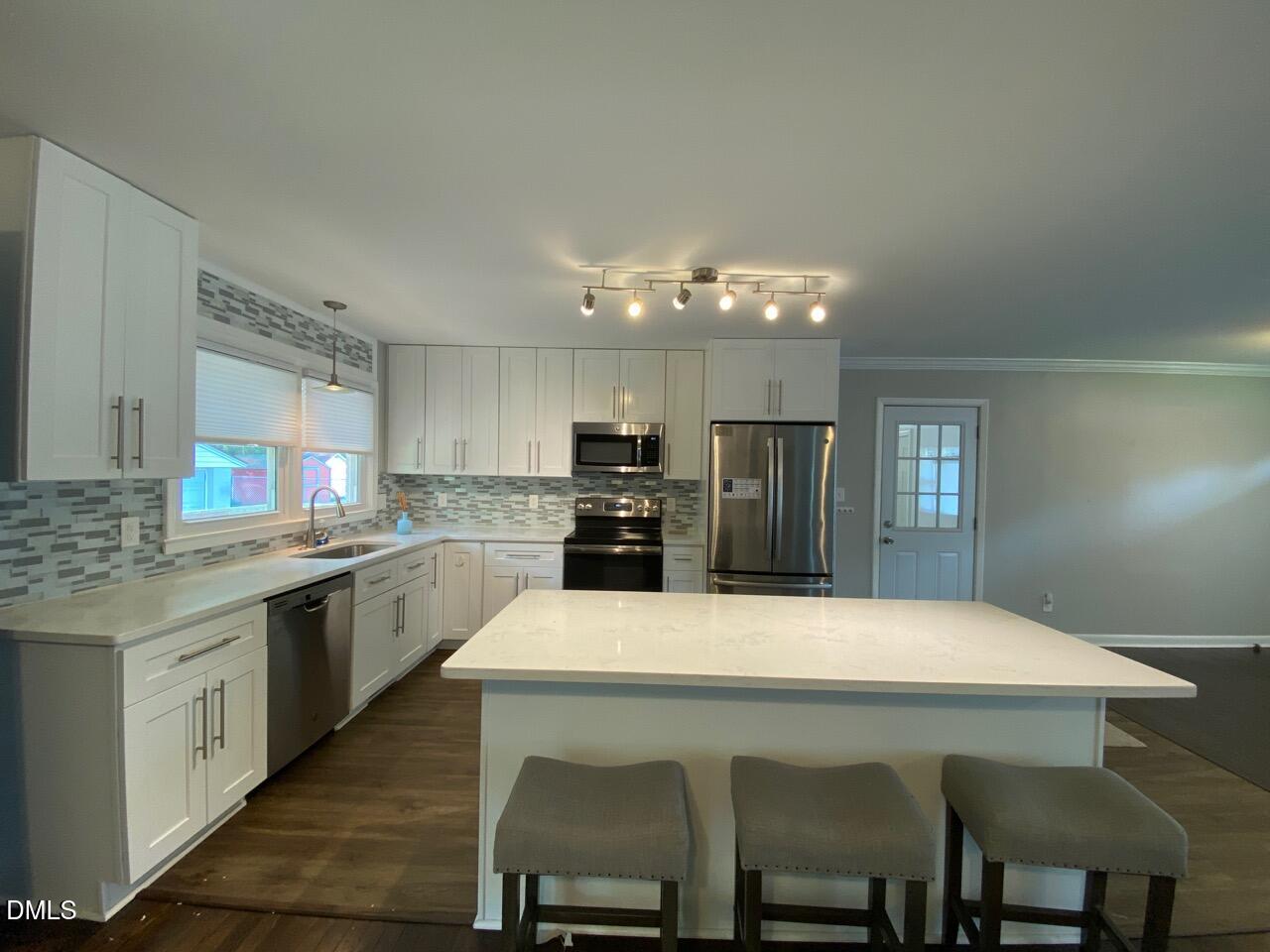 2910 Haven Road Raleigh, NC 27610 - Photo 6 of 26 a large kitchen with a table and chairs