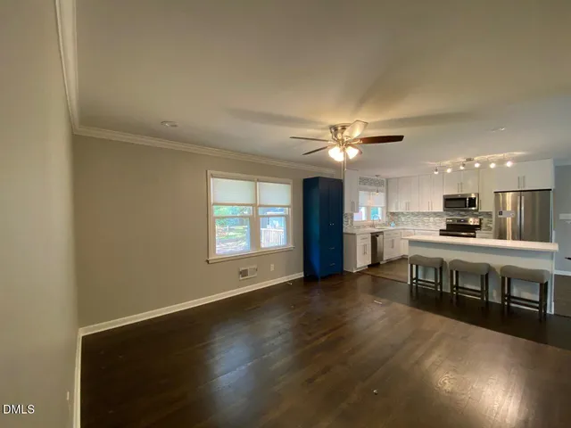 a view of kitchen with microwave and wooden floor