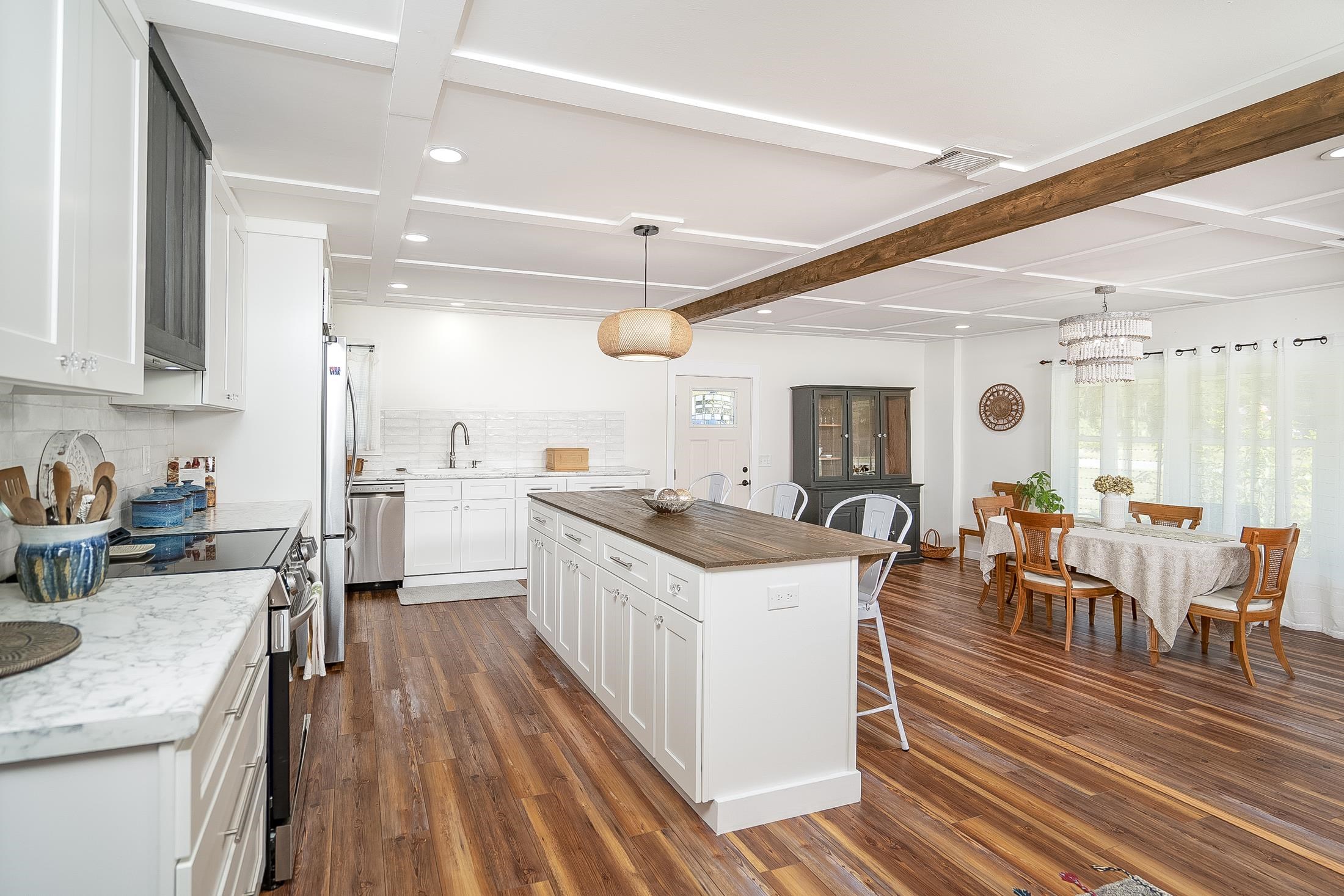 123 Esperanza Grove Road East Palatka, FL 32131 - Photo 11 of 59 Kitchen with decorative light fixtures, butcher block counters, a breakfast bar area, beam ceiling, and white cabinetry