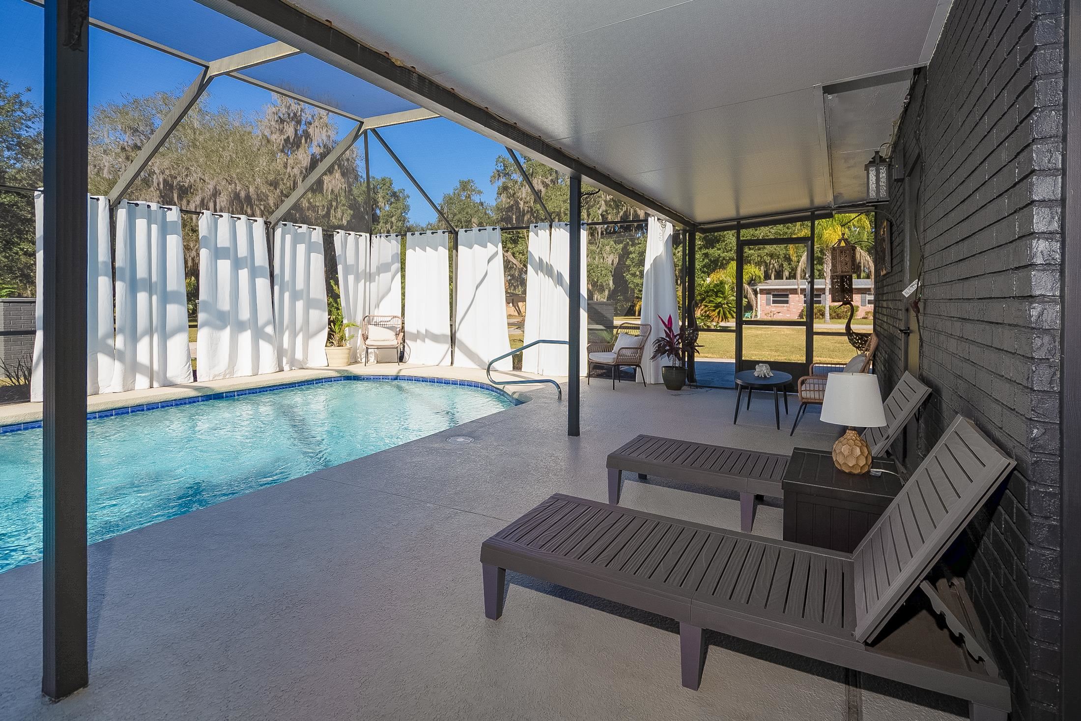 123 Esperanza Grove Road East Palatka, FL 32131 - Photo 18 of 59 View of swimming pool featuring a sunroom, a patio area, and glass enclosure
