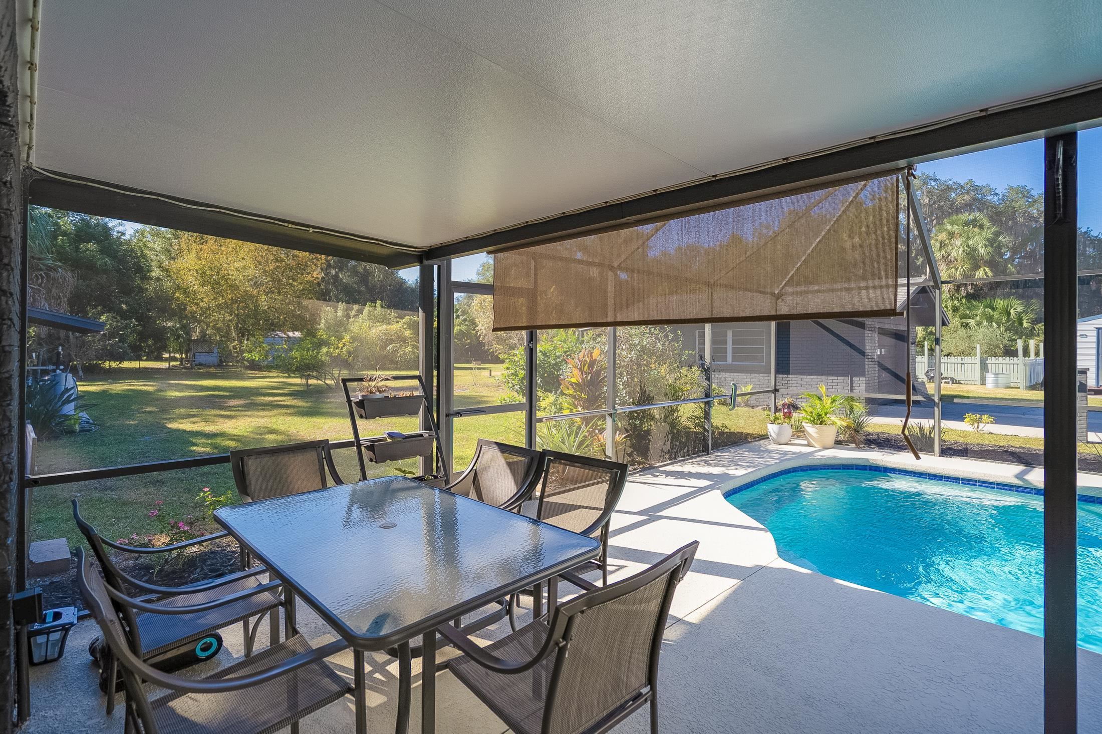 123 Esperanza Grove Road East Palatka, FL 32131 - Photo 19 of 59 Outdoor pool with a sunroom, glass enclosure, and a lawn