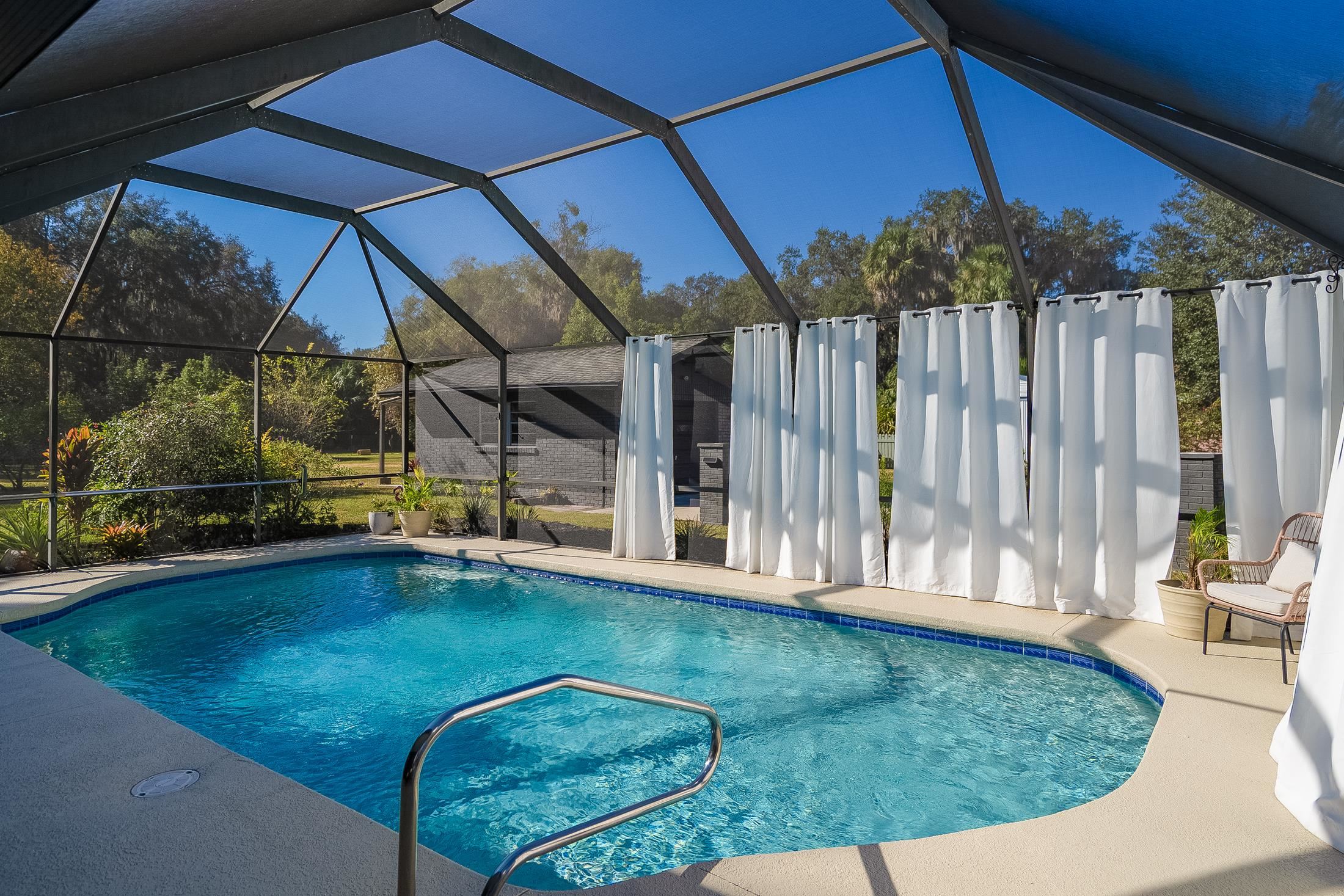 123 Esperanza Grove Road East Palatka, FL 32131 - Photo 22 of 59 Swimming pool with a sunroom, glass enclosure, and a patio