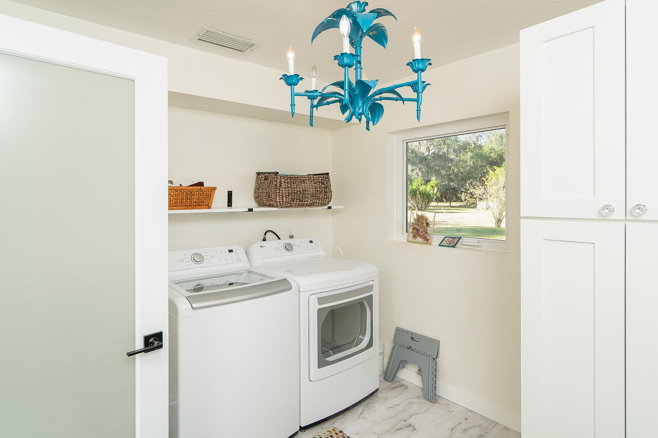 123 Esperanza Grove Road East Palatka, FL 32131 - Photo 34 of 59 a utility room with stainless steel appliances wooden floor and large window