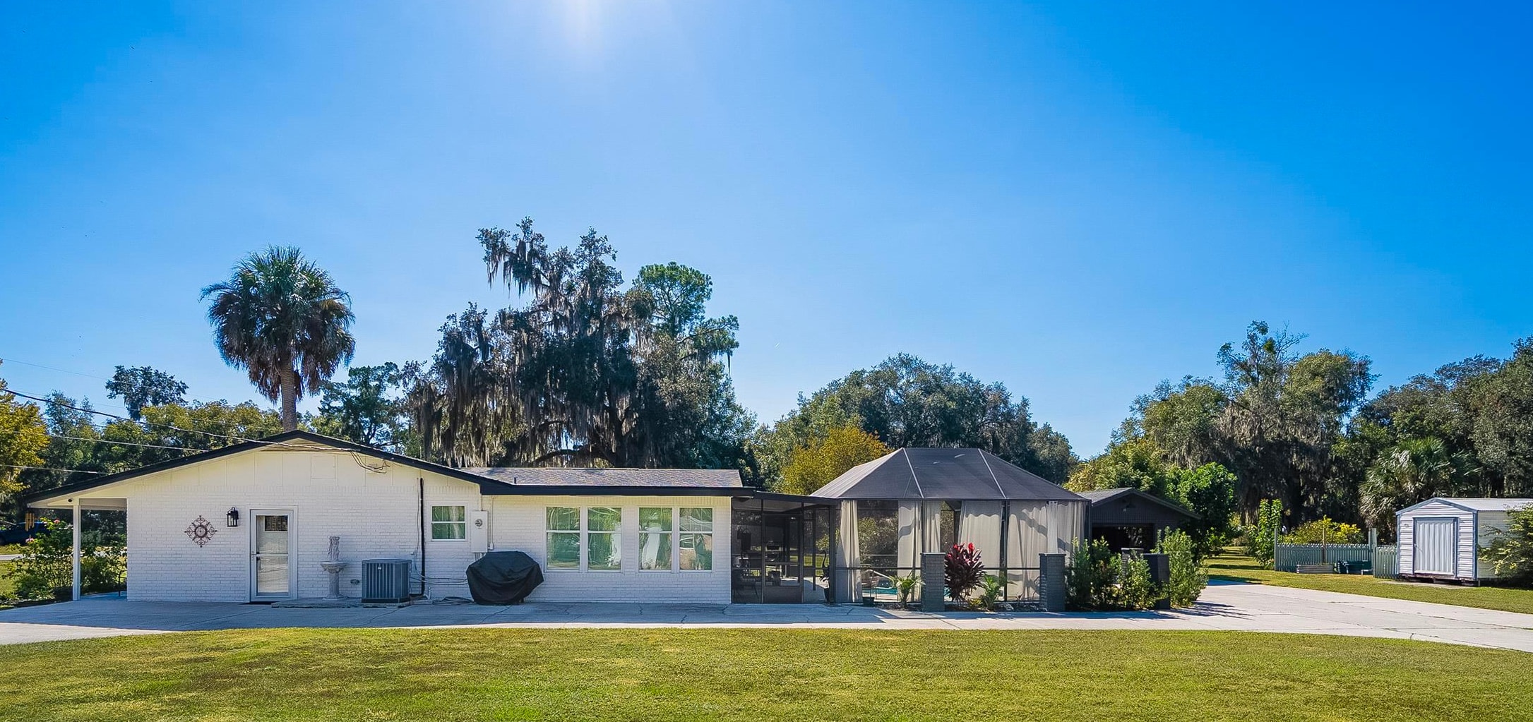 123 Esperanza Grove Road East Palatka, FL 32131 - Photo 38 of 59 Ranch-style house with a front yard, a patio, glass enclosure, and a sunroom
