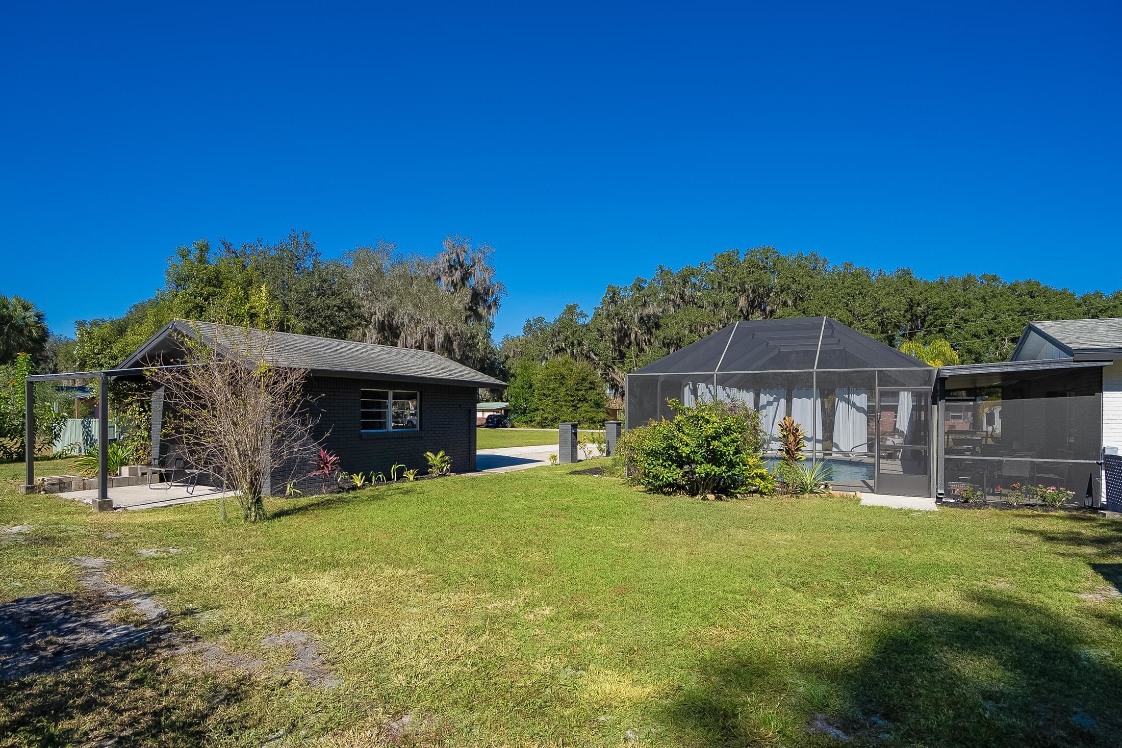 123 Esperanza Grove Road East Palatka, FL 32131 - Photo 41 of 59 Back of garage with a lawn, a lanai