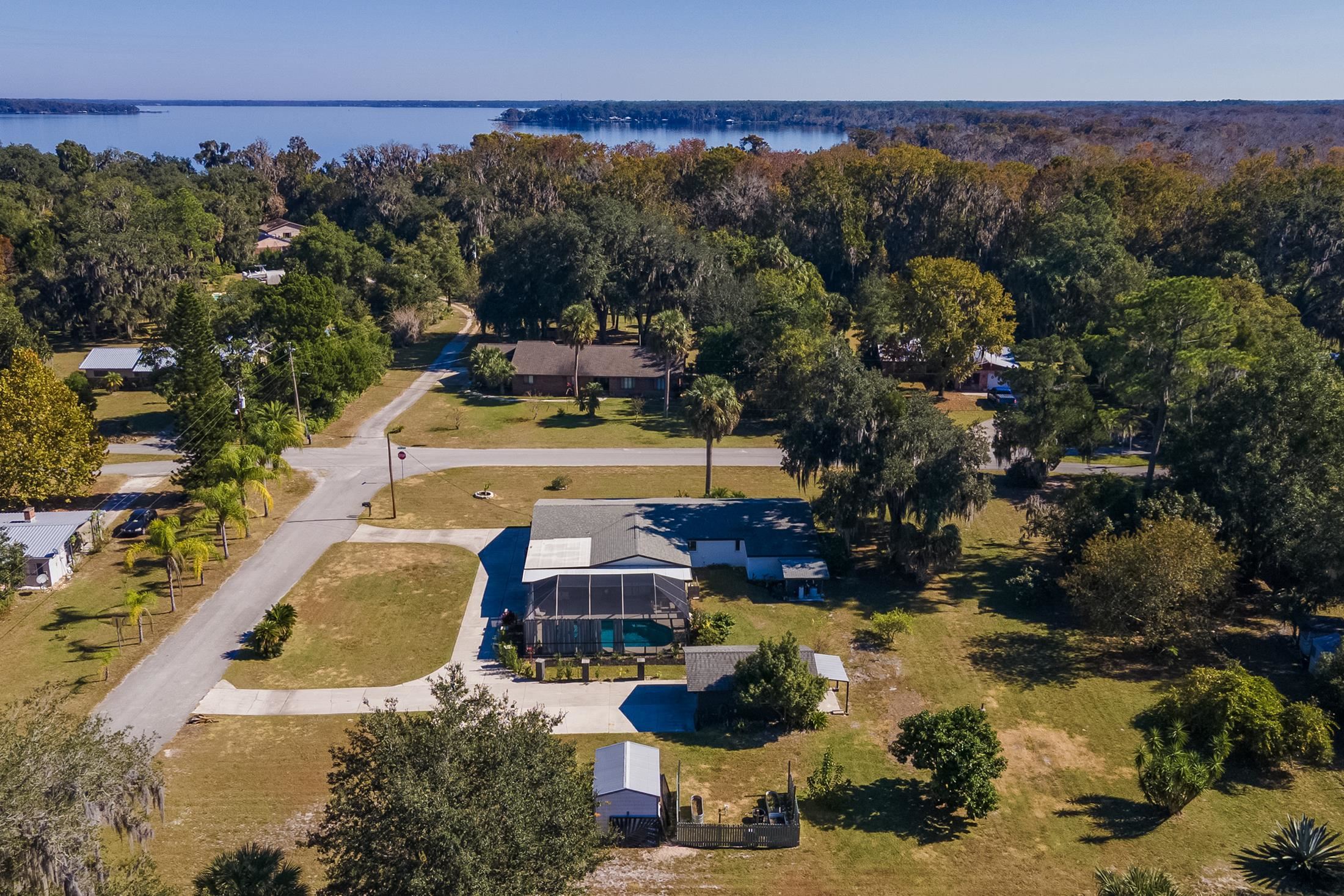 123 Esperanza Grove Road East Palatka, FL 32131 - Photo 49 of 59 Aerial view of property and surrounding area featuring a nearby body of water and a forest