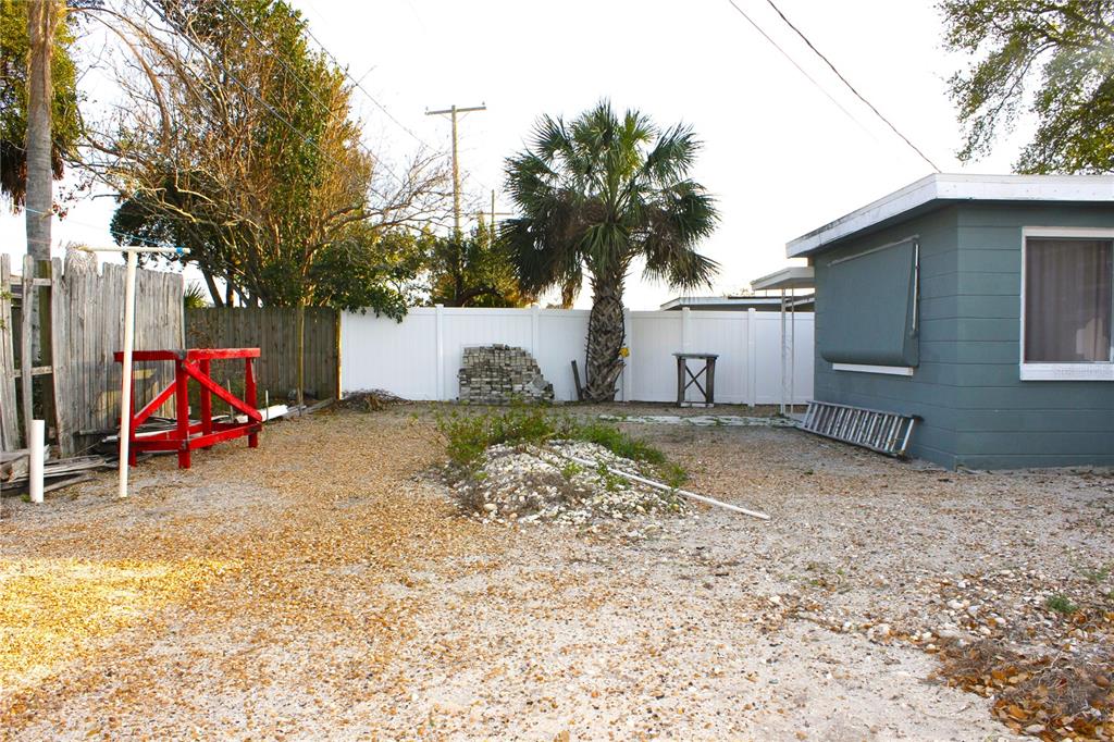 3542 Connon Drive New Port Richey, FL 34652 - Photo 12 of 47 a view of a backyard with a table and chairs