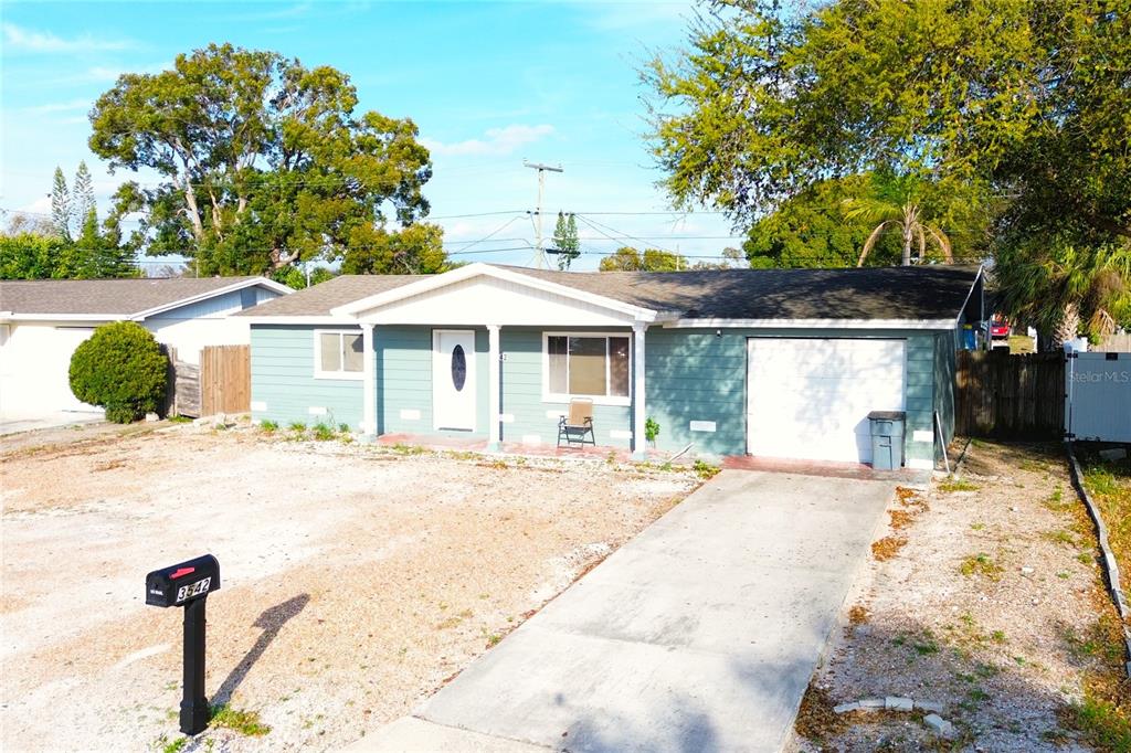 3542 Connon Drive New Port Richey, FL 34652 - Photo 13 of 47 a front view of a house with a yard and potted plants
