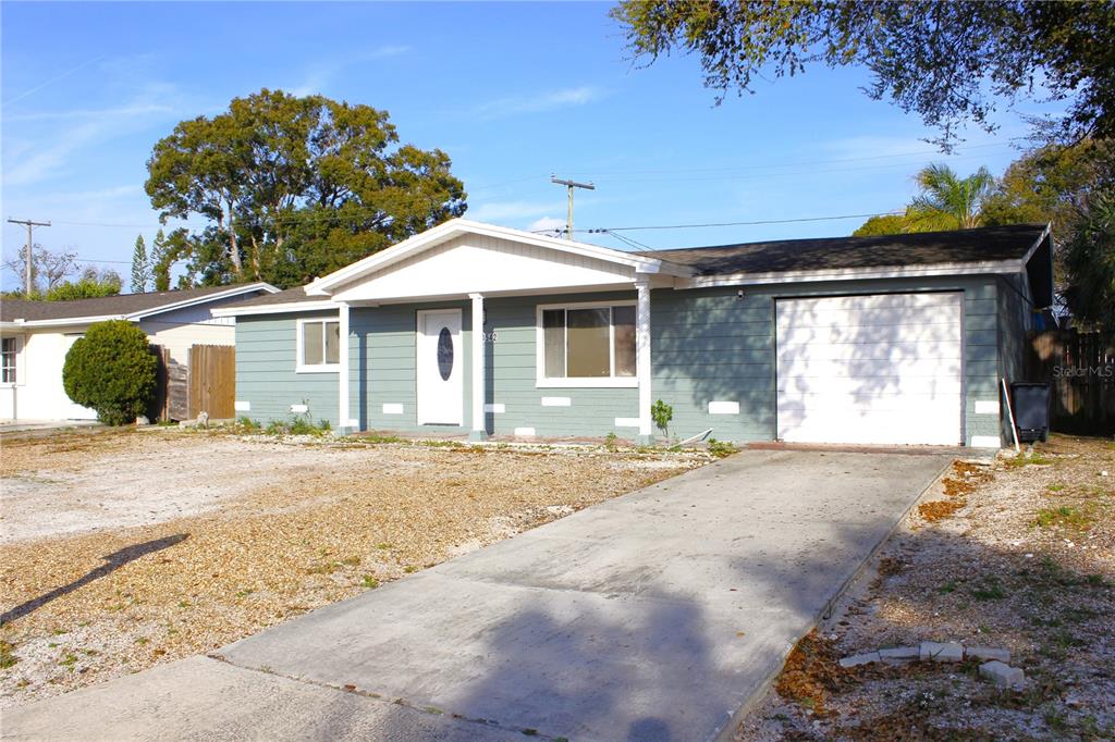 3542 Connon Drive New Port Richey, FL 34652 - Photo 20 of 47 a white house with a large tree in front of it