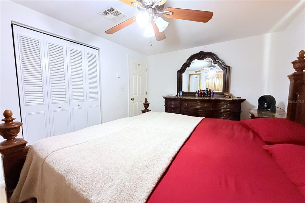 3542 Connon Drive New Port Richey, FL 34652 - Photo 25 of 47 a bedroom with a bed and a chandelier