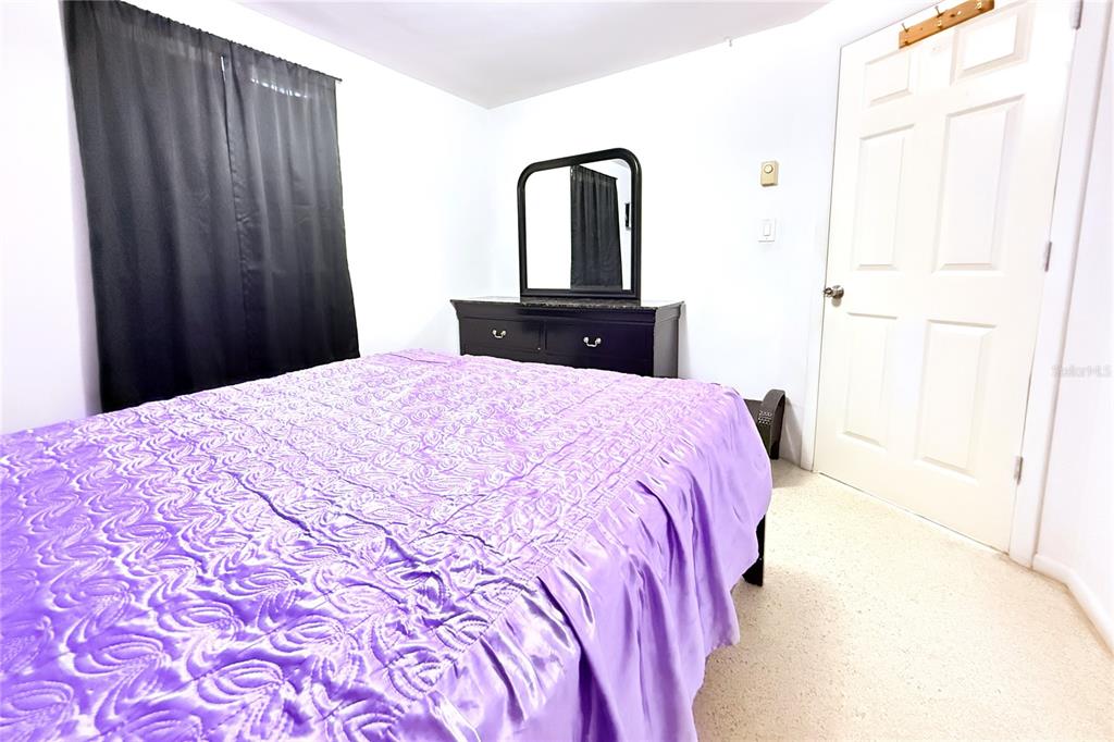 3542 Connon Drive New Port Richey, FL 34652 - Photo 28 of 47 a large bed with a black and white comforter