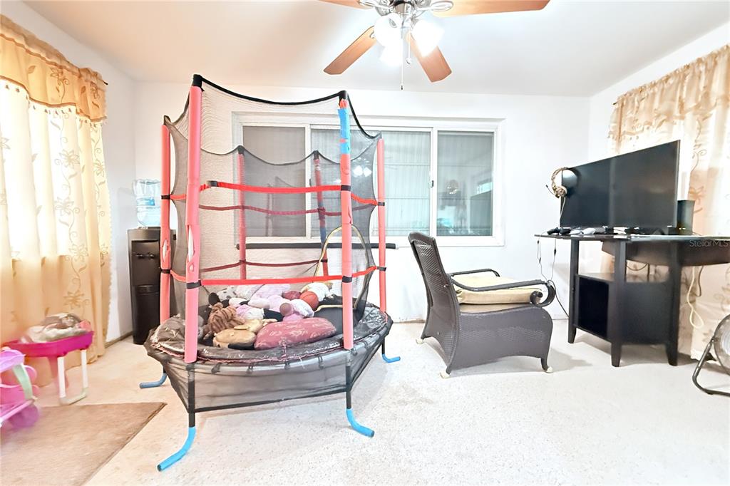 3542 Connon Drive New Port Richey, FL 34652 - Photo 30 of 47 a living room with furniture a flat screen tv and a window