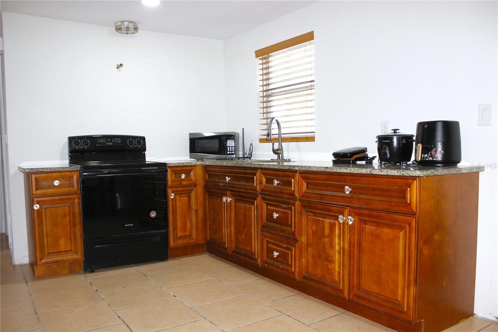 3542 Connon Drive New Port Richey, FL 34652 - Photo 33 of 47 a kitchen with stainless steel appliances granite countertop a refrigerator and a stove