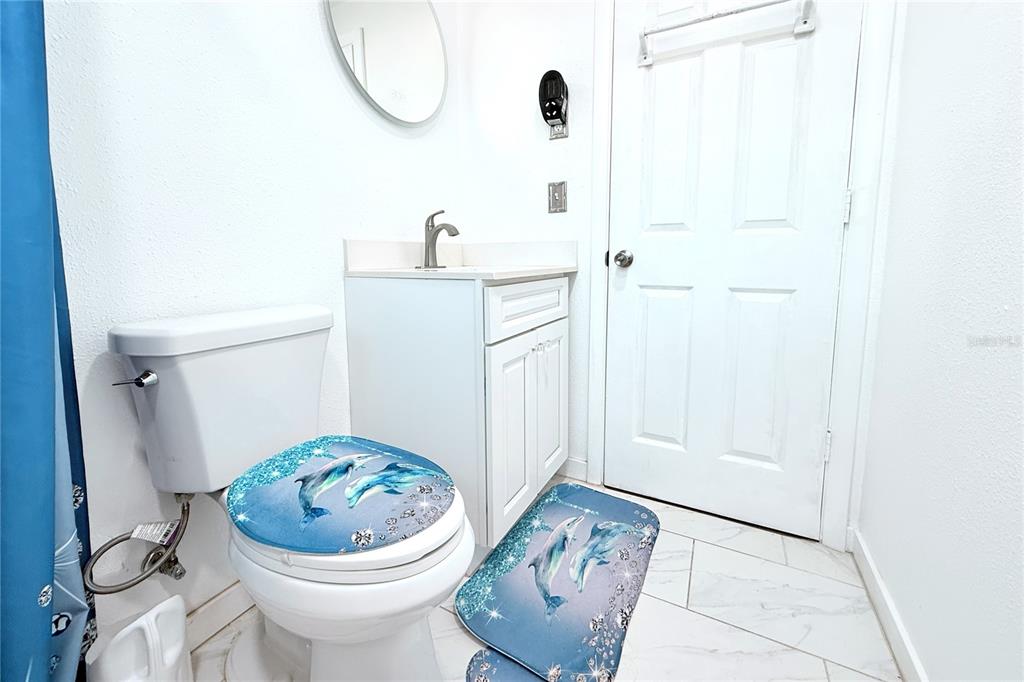 3542 Connon Drive New Port Richey, FL 34652 - Photo 42 of 47 a bathroom with a sink a toilet and a mirror