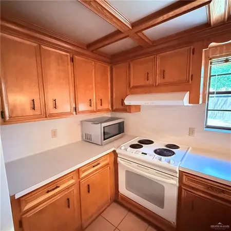 a kitchen with granite countertop cabinets stainless steel appliances and a sink