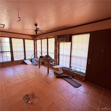 a room with gym equipment and large windows