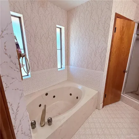 a bathroom with a tub and a shower