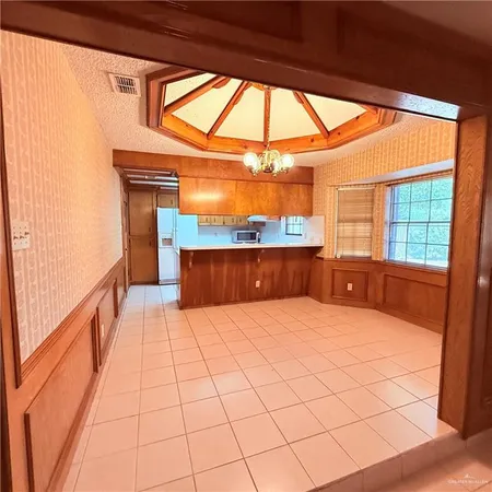 a room with a bed and large window