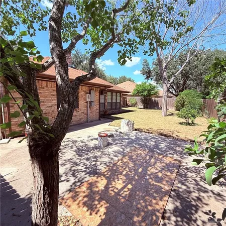 a tree in front of a white house