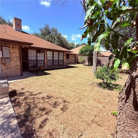 a front view of a house with a yard covered with snow