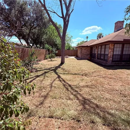 a view of backyard with a table and chairs