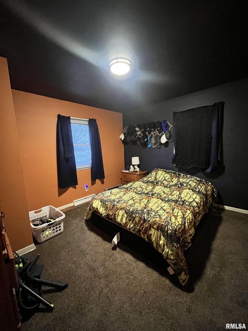 917 South 8th Street Clinton, IA 52732 - Photo 11 of 15 a bed sitting in a room next to a window