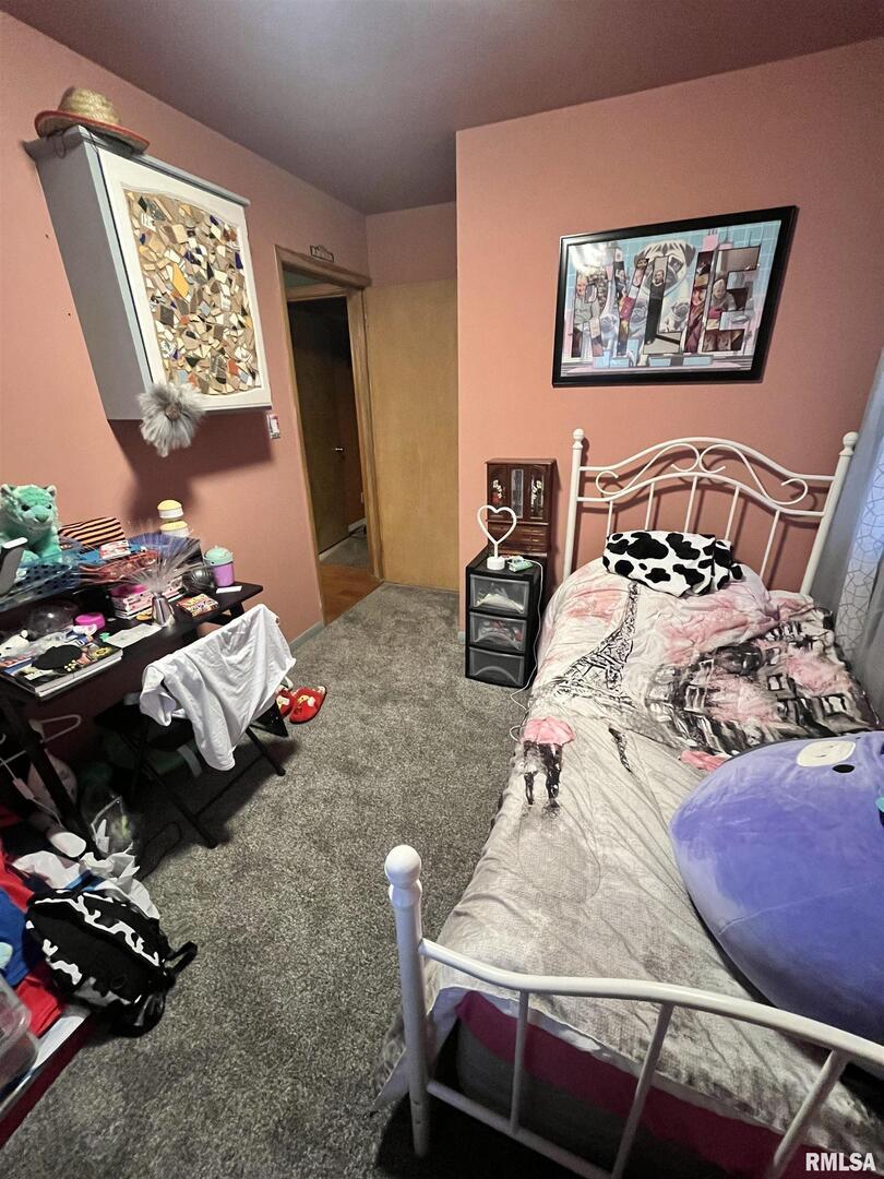 917 South 8th Street Clinton, IA 52732 - Photo 12 of 15 a bedroom with furniture and a bed