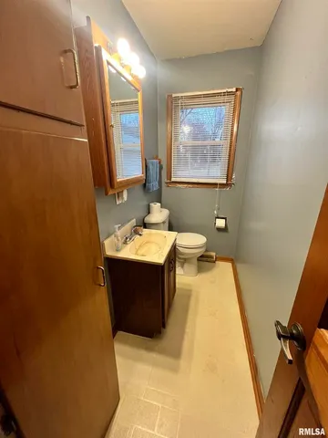 a bathroom with a bathtub sink mirror vanity and toilet