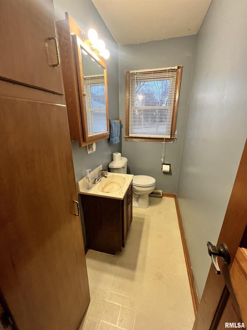 917 South 8th Street Clinton, IA 52732 - Photo 5 of 15 a bathroom with a bathtub sink mirror vanity and toilet