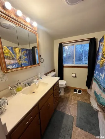 a bathroom with a sink a vanity and a mirror