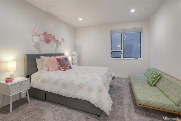 a bedroom with a bed and a couch