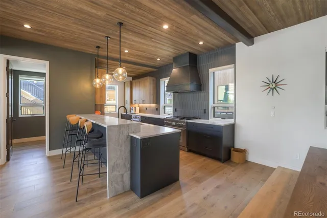 a kitchen with a sink cabinets and wooden floor