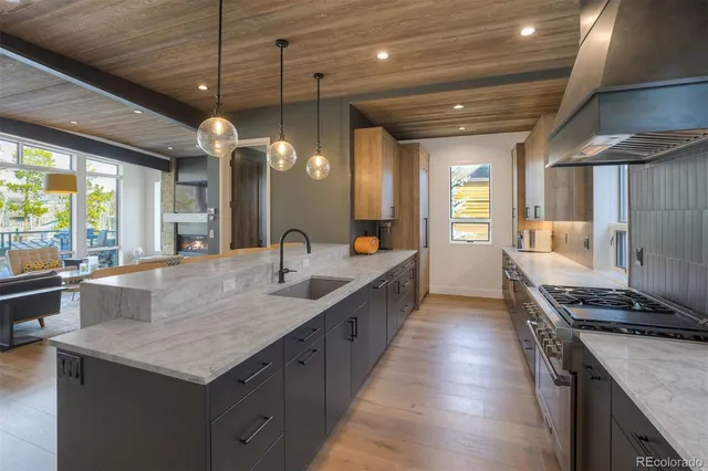 a kitchen with sink stove and refrigerator