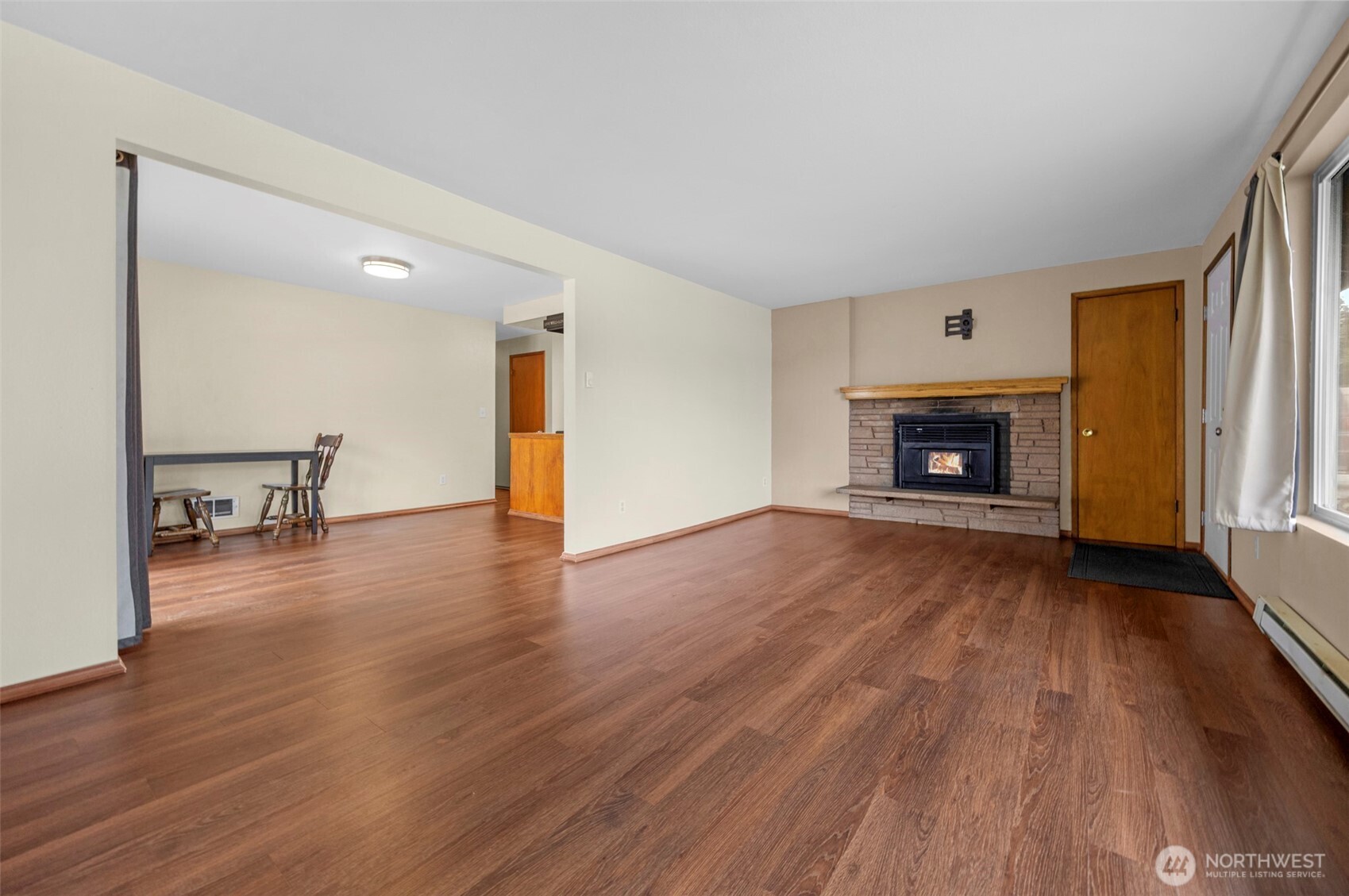 212 Madison Street Everett, WA 98203 - Photo 17 of 40 an empty room with wooden floor fire place and windows