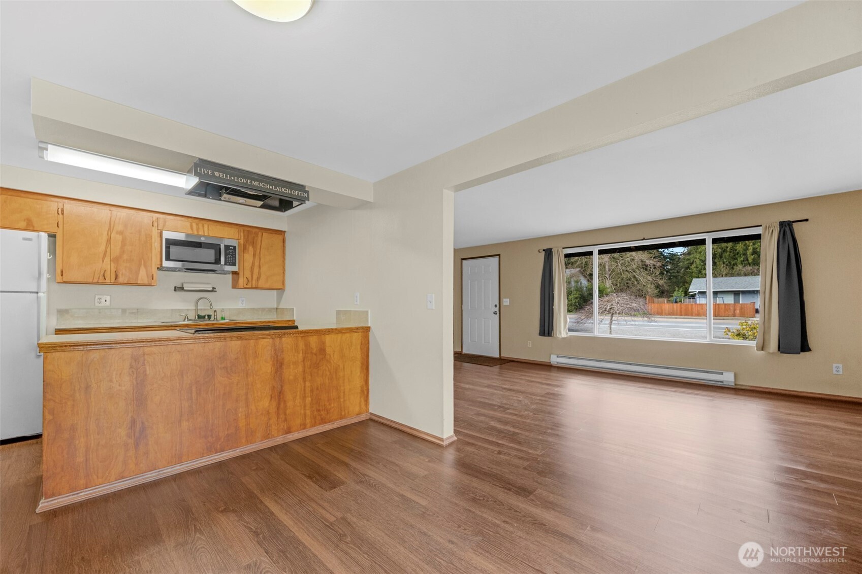 212 Madison Street Everett, WA 98203 - Photo 3 of 40 a view of a kitchen with wooden floor and a window