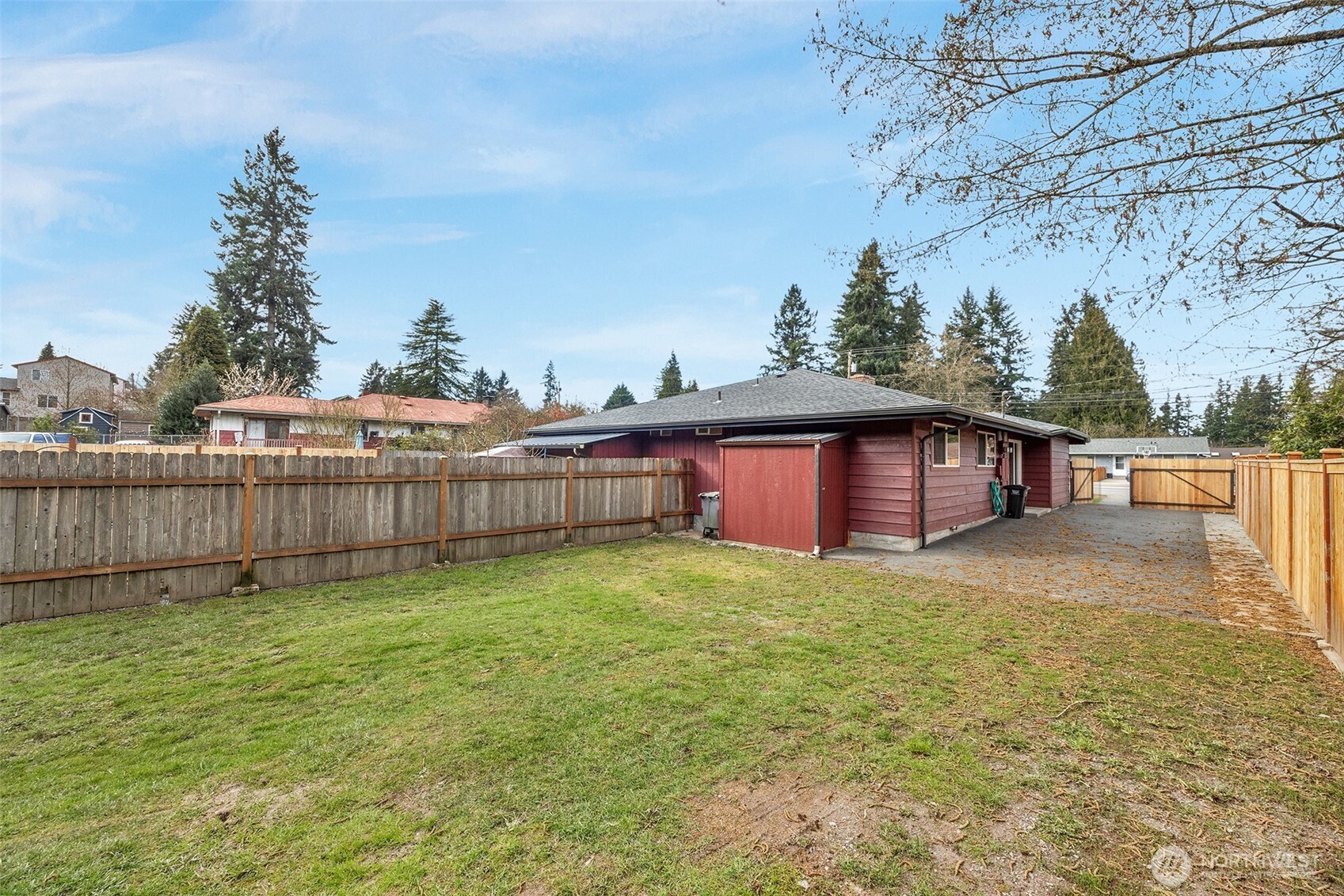 212 Madison Street Everett, WA 98203 - Photo 33 of 40 a view of a small yard with a large tree and wooden fence