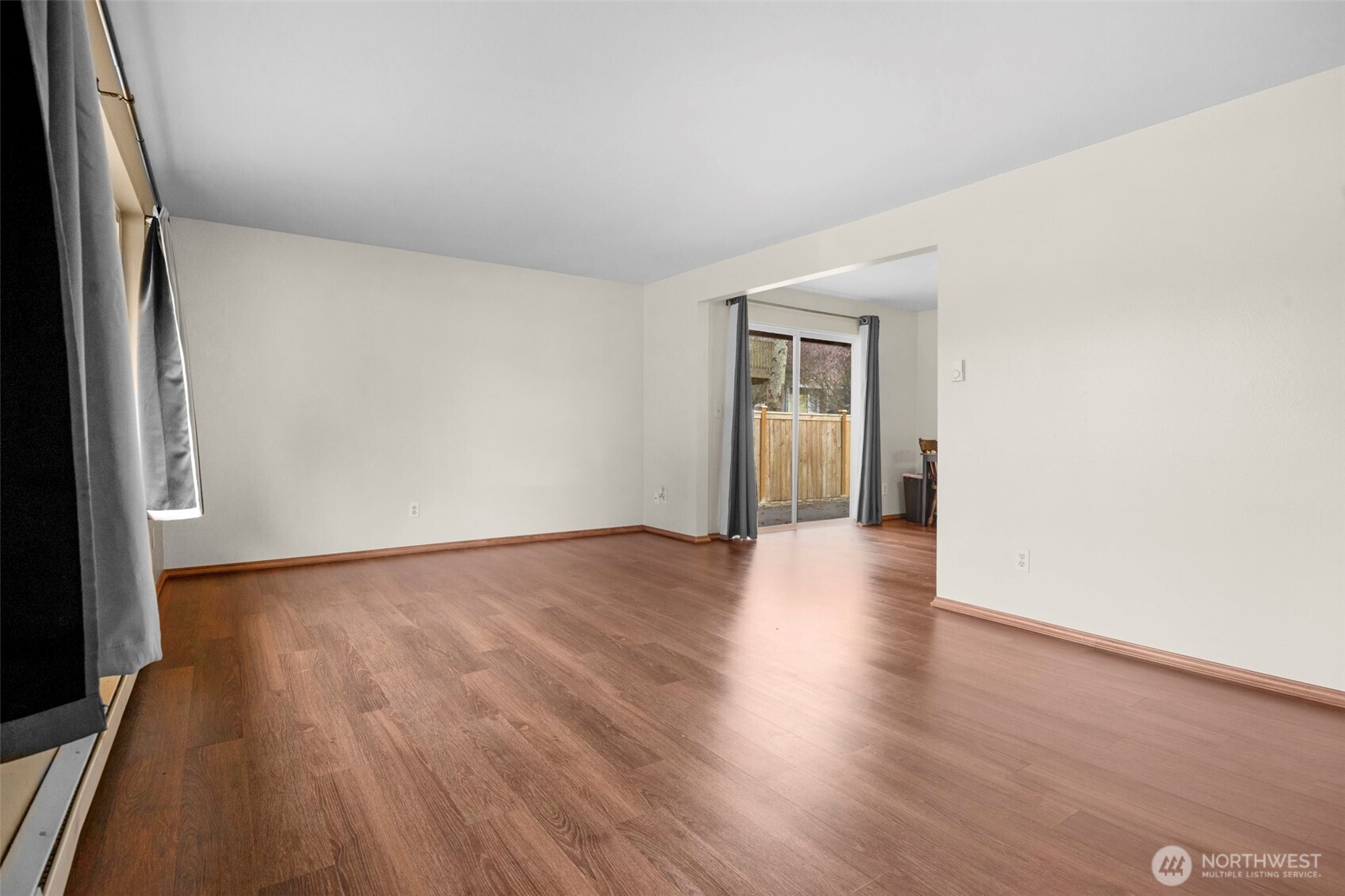 212 Madison Street Everett, WA 98203 - Photo 4 of 40 a view of an empty room with wooden floor and a window