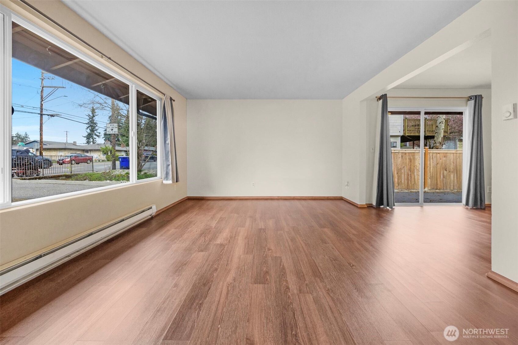 212 Madison Street Everett, WA 98203 - Photo 5 of 40 a view of an empty room with wooden floor and a window