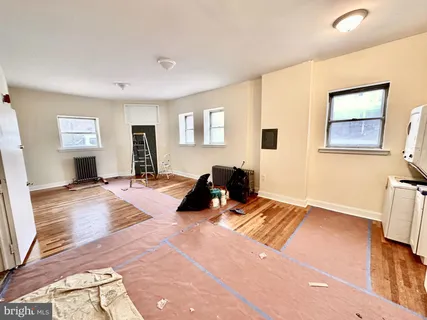 a bed room with a bed and a view of living room