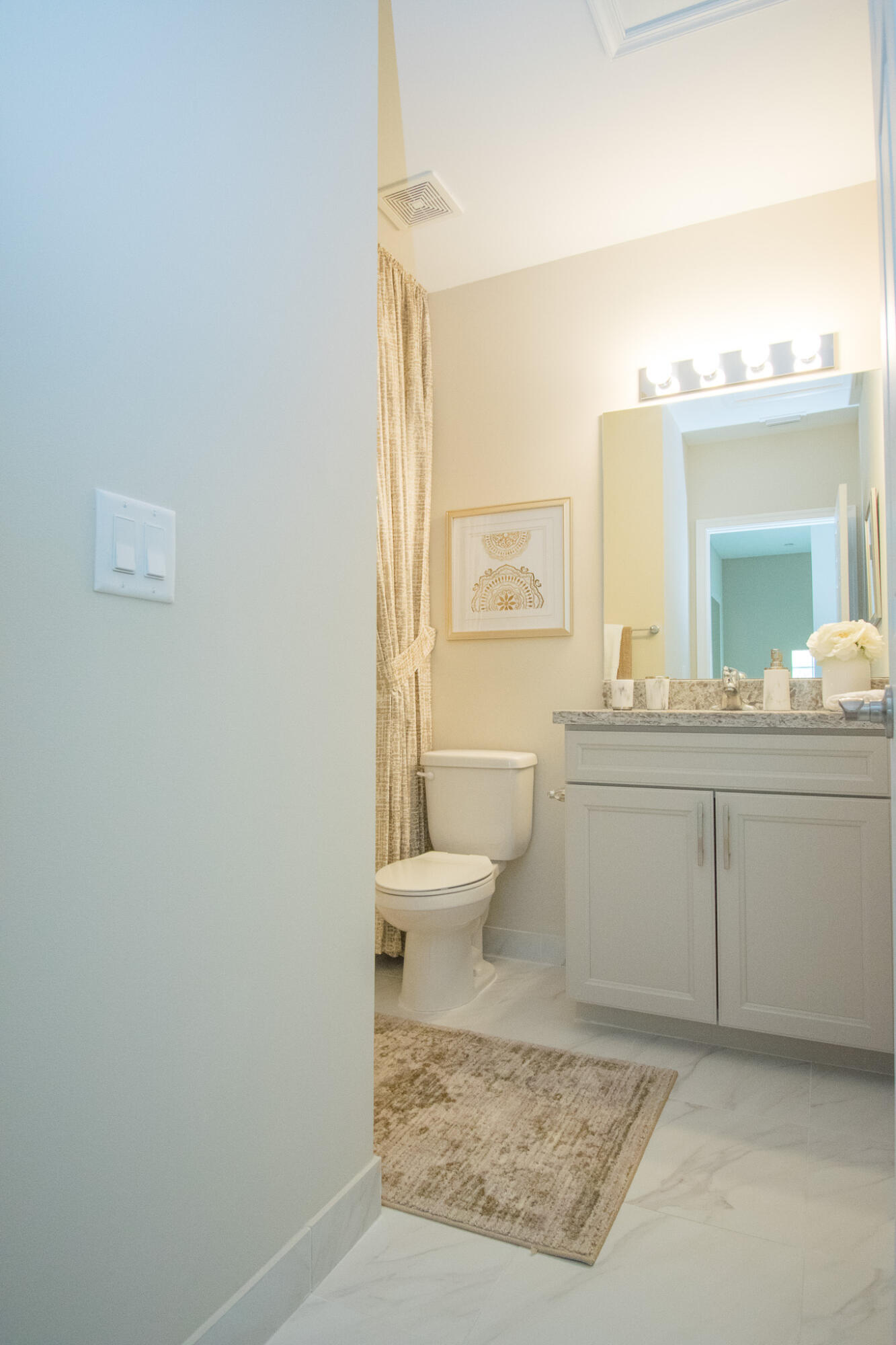14377 Sims Road, Unit 14390 Delray Beach, FL 33484 - Photo 10 of 13 a bathroom with a toilet a sink a vanity and mirror