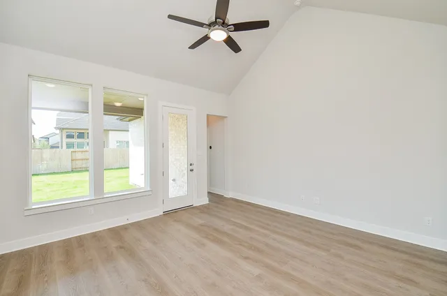 wooden floor in an empty room with a window
