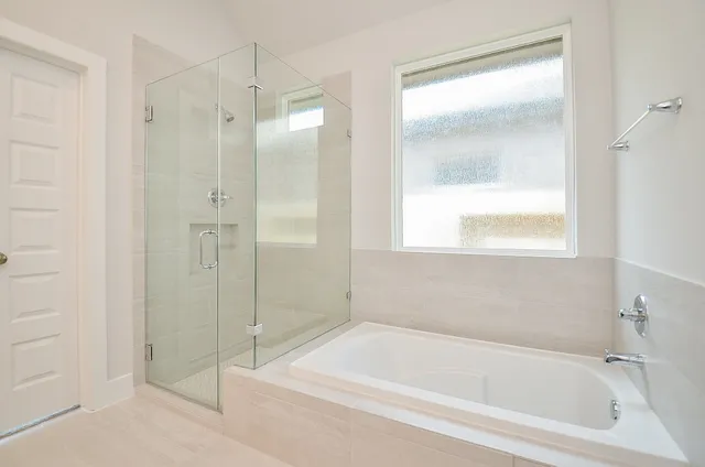 a bathroom with a bathtub and a shower