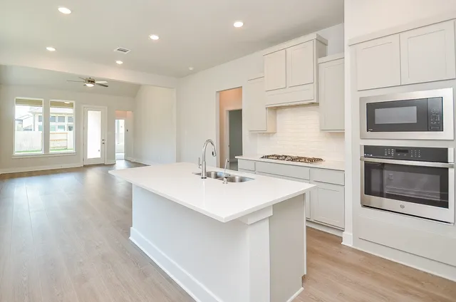 a kitchen with counter top space cabinets and stainless steel appliances