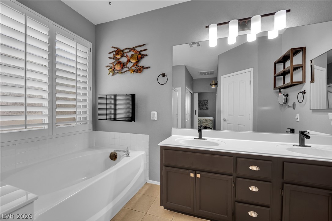 1724 Millstream Way Henderson, NV 89074 - Photo 30 of 60 Relax in the deep soaking tub or prepare for your day at the convenient dual sink vanity.