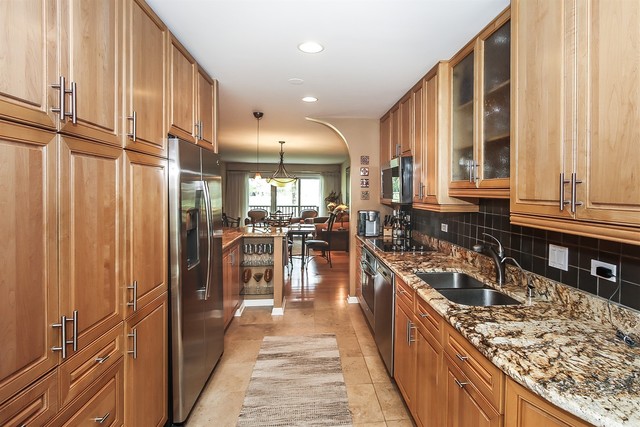 241 Timber Ridge Lane Lake Barrington, IL 60010 - Photo 12 of 33 a kitchen with stainless steel appliances granite countertop a refrigerator a sink dishwasher a stove and a flat oven with wooden floor