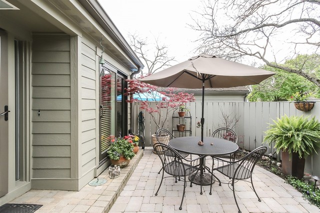 241 Timber Ridge Lane Lake Barrington, IL 60010 - Photo 3 of 33 a view of a patio with table and chairs under an umbrella with potted plants