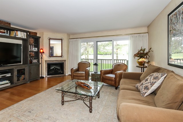 241 Timber Ridge Lane Lake Barrington, IL 60010 - Photo 6 of 33 a living room with furniture a flat screen tv and a fireplace