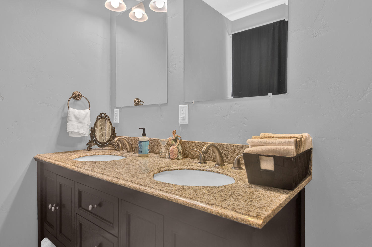 19112 Pumice Butte Road Bend, OR 97702 - Photo 28 of 36 a bathroom with a granite countertop sink and a mirror