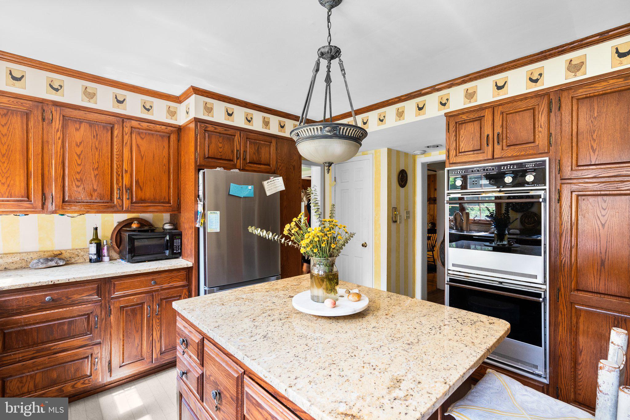 13321 Travilah Road Potomac, MD 20854 - Photo 17 of 43 a kitchen with stainless steel appliances granite countertop a sink a stove and refrigerator