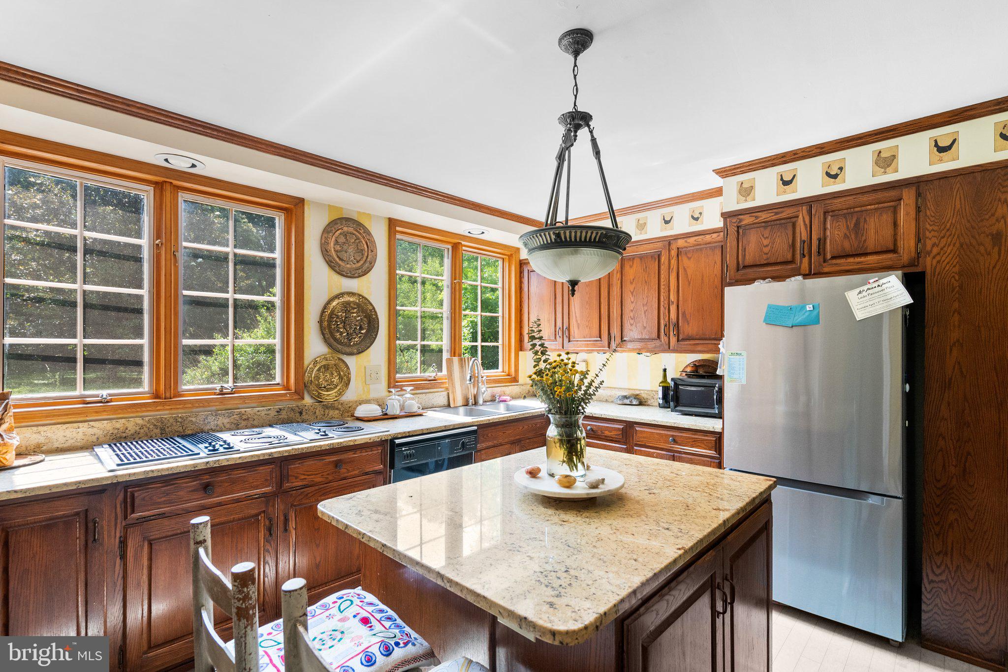 13321 Travilah Road Potomac, MD 20854 - Photo 18 of 43 a kitchen with sink refrigerator and large window